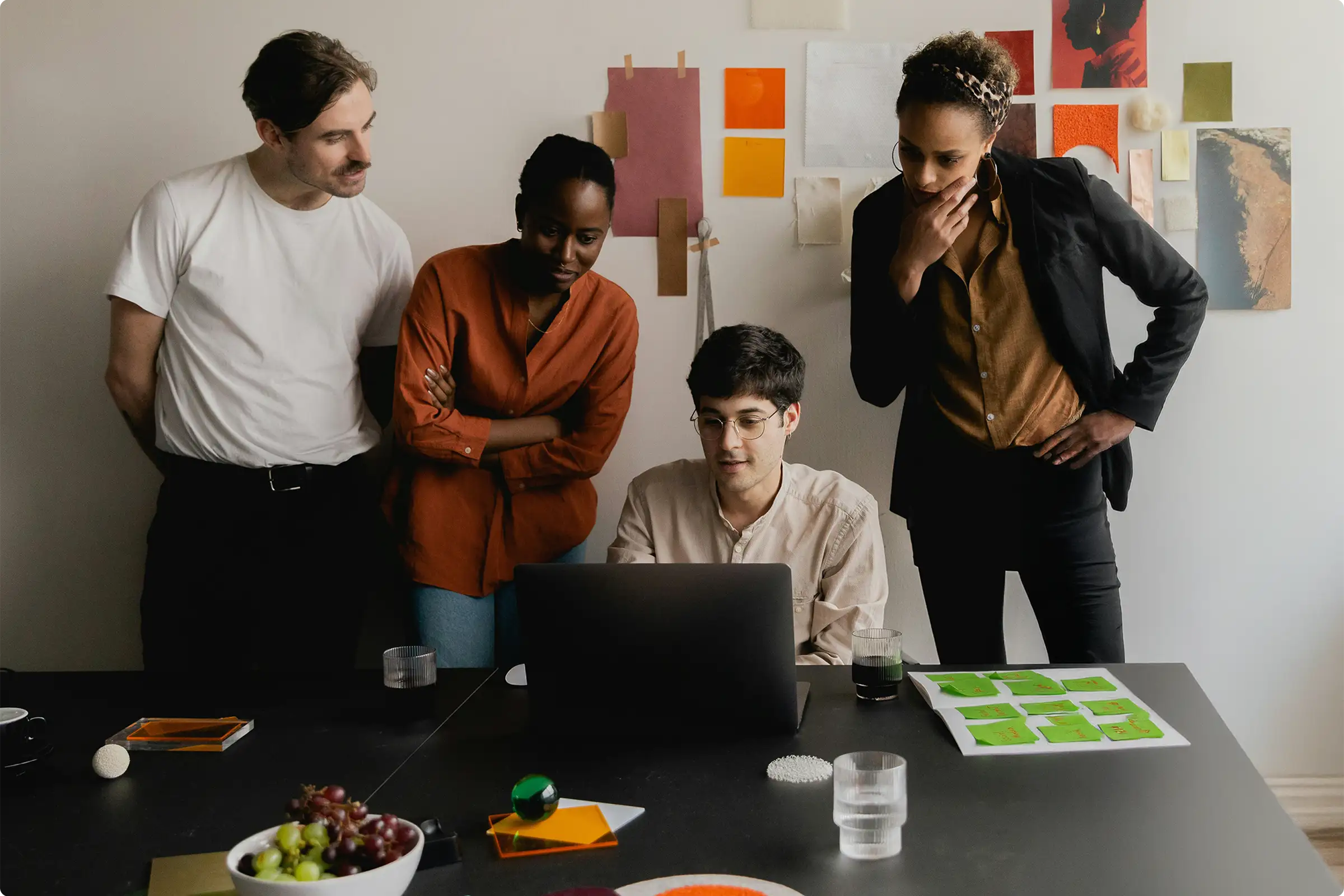 group of people looking at a laptop